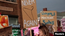 FILE - Supporters of Planned Parenthood rally outside a Planned Parenthood clinic in Detroit, Michigan, Feb. 11, 2017.