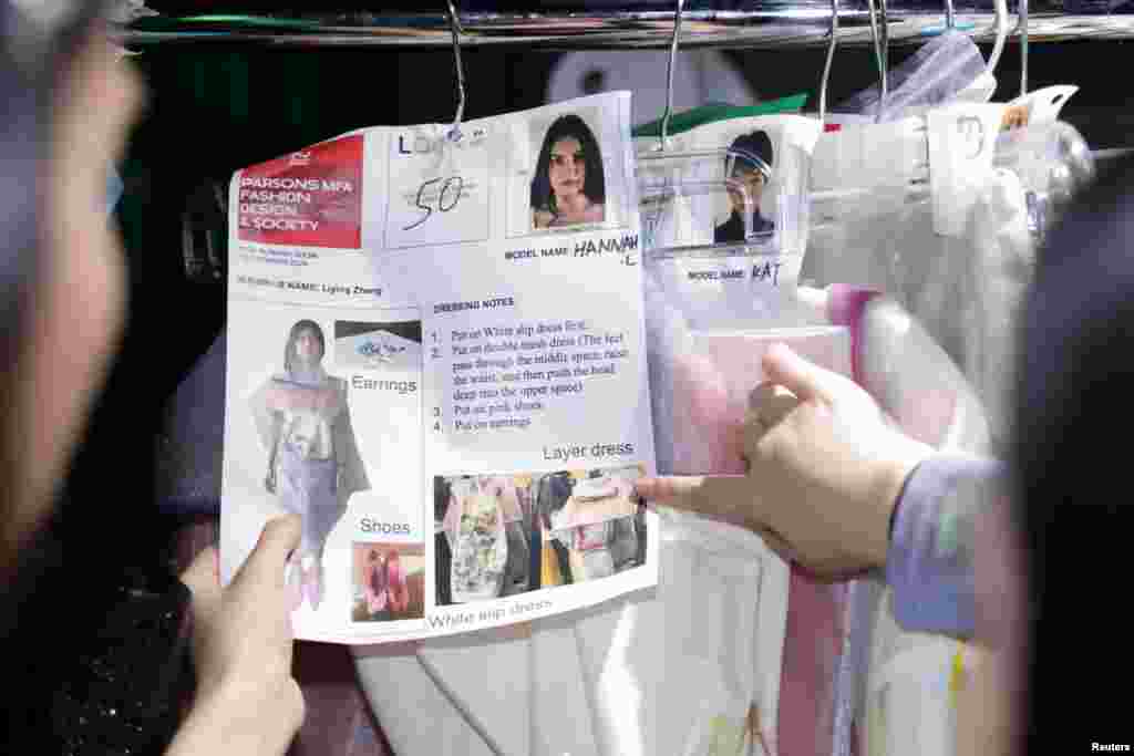Designers point to a dress before models present creations from the Parsons School Spring/Summer 2025 presentation during New York Fashion Week in New York City, Sep. 9, 2024.