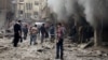 Syrians try to extinguish a fire after an aerial bombardment, blamed on the Assad government, on the Damascus suburb of Douma. The Douma Revolution News Network published the image on its Facebook page Dec. 13, 2015. 