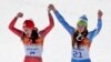 Women's downhill gold medal winners Switzerland's Dominique Gisin, left, and Slovenia's Tina Maze step onto the podium together at the Sochi 2014 Winter Olympics, Feb. 12, 2014, in Krasnaya Polyana, Russia.