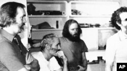 FILE - Four American hostages held in Iran listen to the latest demands for their release on Dec. 25, 1980. From left: William Belk of Columbia, S. C.; Thomas Schaefer of Tacoma, Wash.; Donald Hohman of West Sacramento, Calif.; and John Craves of Reston, 