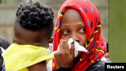 Relatives grieve after learning a loved one was killed in an attack on an upscale hotel compound, in Nairobi, Kenya, Jan. 16, 2019.