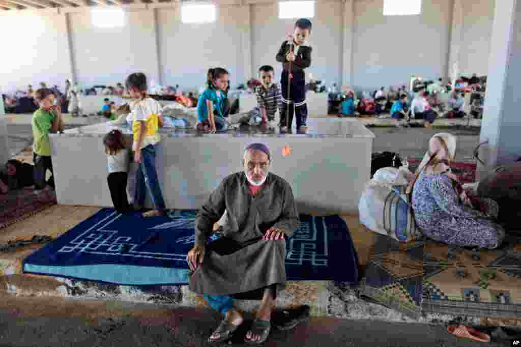 A Syrian man takes refuge at the Bab Al-Salameh border crossing in Azaz, August 23, 2012. Thousands of Syrians who have been displaced are struggling to find safe shelter while shelling and airstrikes continue.