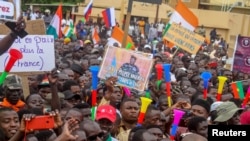 Thousands of anti-sanctions protestors holding Nigerien flags and Russian flags gather in support of the putschist soldiers in the capital Niamey, Niger, Aug. 20, 2023. 