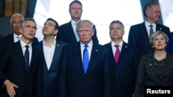 From left, NATO Secretary General Jens Stoltenberg, Greek Prime Minister Alexis Tsipras, U.S. President Donald Trump, Hungarian Prime Minister Voktor Orban and Britain's Prime Minister Theresa May pose for a family photo during a NATO summit at their new headquarters in Brussels, Belgium, May 25, 2017. 
