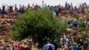 FILE - Miners gather on a hill during their strike at the AngloGold Ashanti Mine in Fochville near Johannesburg, South Africa, Oct. 19, 2012.