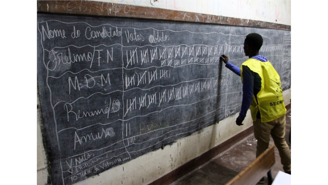 FILE - Vote counting takes place after the polling station closed in Maputo, Mozambique, Oct. 15, 2019.