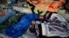 Refugees and migrants from the destroyed Moria camp sleep on the side of a road, on the island of Lesbos, Greece, Sept. 13, 2020.