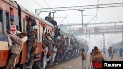 Commuters travel in an overcrowded train near a railway station in Ghaziabad, on the outskirts of New Delhi, India, Feb. 1, 2019. 