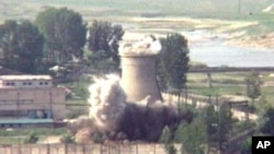 FILE - In this June 27, 2008 file image from TV, the demolition of the 60-foot-tall cooling tower at its main reactor complex in Yongbyon North Korea. North Korea’s Foreign Ministry said Saturday May 12, 2018, it will hold a “ceremony” for the dismantling of its nuclear test site on May 23-25 in what would be a dramatic but symbolic event to set up the summit meeting between Kim Jong Un and US President Donald Trump scheduled for next month.
