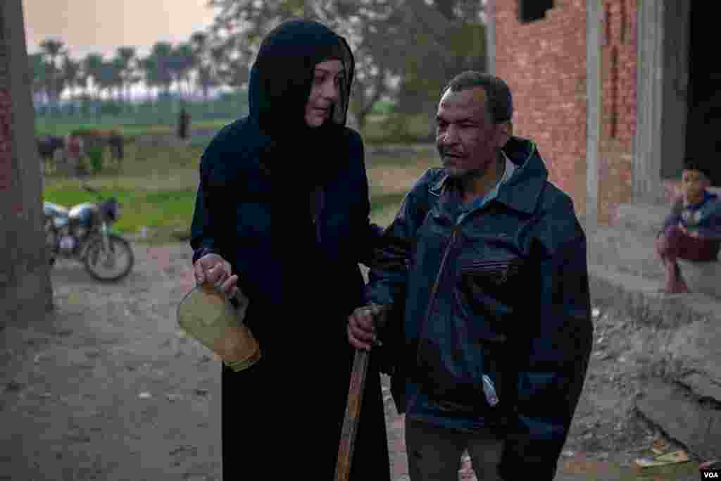 Most of Abdallah's clients treat him with compassion, almost as a family member, and sometimes they give him a hand in reaching his next client. (Hamada Elrasam/VOA)