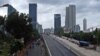 FILE - In this Jan. 11, 2013, photo, workers build an elevated highway in Jakarta, Indonesia. 