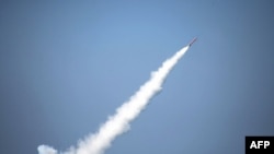 FILE - This file handout image released by Pakistan's Inter Services Public Relations (ISPR) office on Jan. 9, 2017 shows a Pakistani nuclear-capable cruise missile after being launched from a submarine during a test firing at an undisclosed location in Pakistan. (AFP Photo/ISPR)