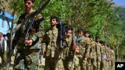 FILE - Militiamen loyal to Ahmad Massoud, son of the late Ahmad Shah Massoud, take part in a training exercise in Panjshir province, northeastern Afghanistan, on Aug. 29, 2021.