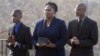FILE - Isatu Salia carriers the cremated remains of her husband, Ebola victim Dr. Martin Salia, while their sons Maada Martin Salia, 20, right, and Hinwaii Sakatty Salia, 12, walk with her to enter St. Mary's Church in Landover Hills, Md., for a funeral Mass, Nov. 29, 2014.