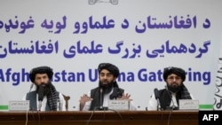 Taliban spokesman Zabihullah Mujahid, center, speaks during a press conference in Kabul on June 30, 2022.