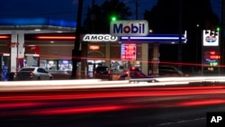 Motorists stop for fuel at gas stations in Detroit, July 5, 2022. The average U.S. price of regular-grade gasoline plunged 19 cents over the past two weeks to $4.86 per gallon. Industry analyst Trilby Lundberg of the Lundberg Survey said Sunday that the
