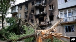 A view of an apartment building damaged during shelling in Donetsk, in territory controlled by the Russia-backed self-proclaimed Donetsk People's Republic, eastern Ukraine, June 22, 2022. 
