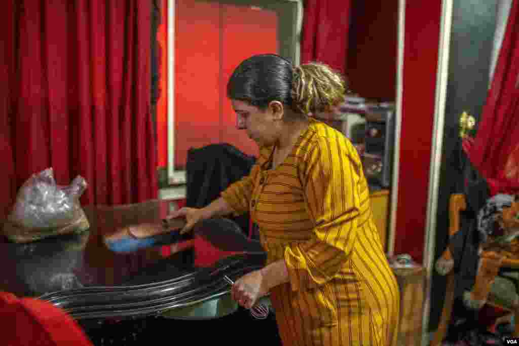 Marina cleans her Cairo home, June 26, 2022. The International Labor Organization's latest statistics on Egypt's workforce show that while more than 67% of men are employed, some 18% of women are wage earners, including both the formal and informal sectors.