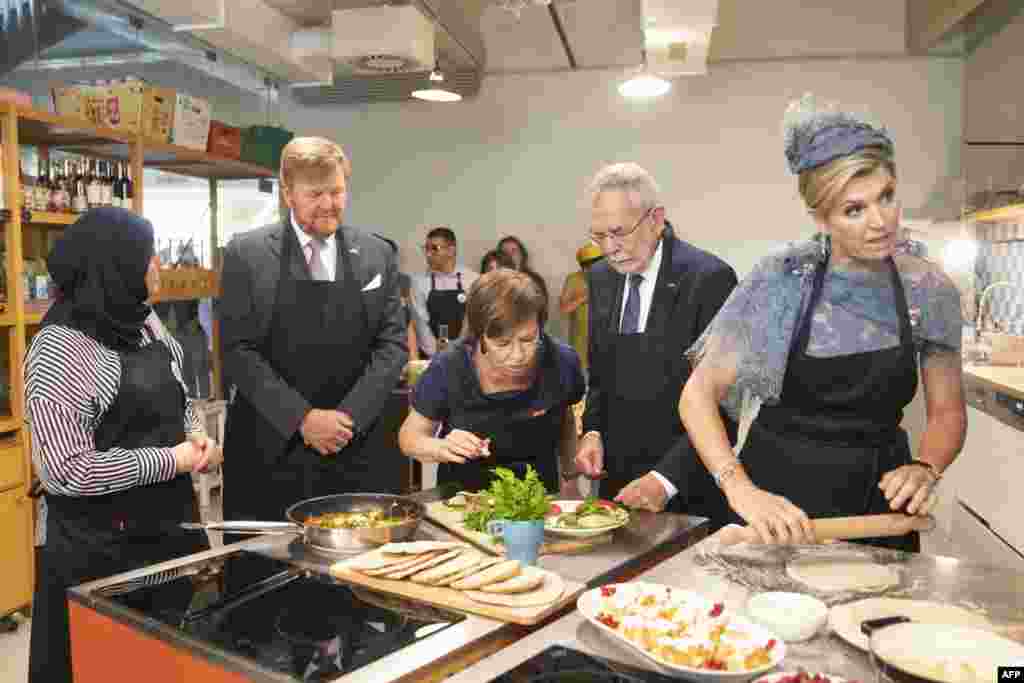 King Willem-Alexander of the Netherlands (2nd L) and Queen Maxima of the Netherlands (R) together with Austrian President Alexander Van der Bellen (2nd R) and his wife Doris Schmidauer (C) visit the "Community Cooking" project of Caritas in the Brotfabrik Vienna, Austria.