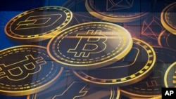FILE - An advertisement of Bitcoin, one of the cryptocurrencies, is displayed on a building in Hong Kong, Nov. 18, 2021. Bitcoin and other cryptocurrencies were collapsing in price, June, 13, 2022 after the major crypto lender Celsius halted all withdrawa
