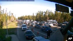 Traffic is backed up at the West Entrance gate at Yellowstone National Park in Montana, June 22, 2022, in this photo provided by National Park Service.