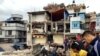 People survey a site damaged by an earthquake, in Kathmandu, Nepal, April 25, 2015. 