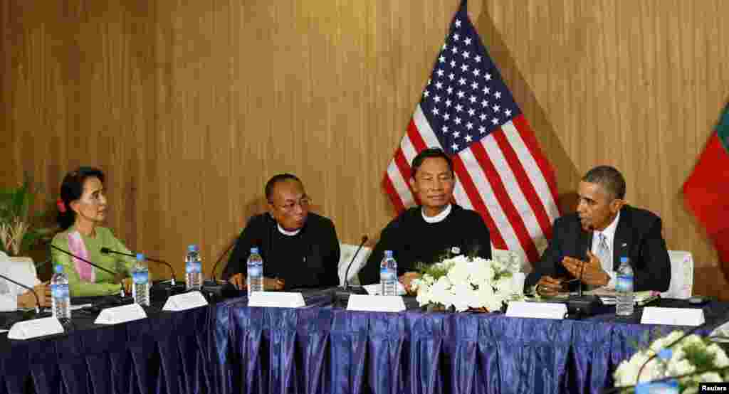 President Barack Obama speaks to Myanmar opposition leader Aung San Suu Kyi (left) during a roundtable with members of parliament and civil society to discuss Myanmar's reform process in Naypyitaw, Myanmar, Nov. 13, 2014.