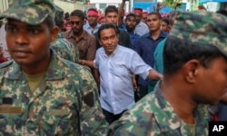 Maldivian President Abdulla Yameen, center, surrounded by his body guards arrives to address his supporters in Male, Feb. 3, 2018.