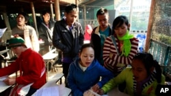 Karen refugees practice their singing before a morning prayers at a church inside Mae La refugee camp in Tha Song Yang district, Tak province northern Thailand, Jan. 19, 2012.