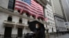 A man wearing a mask walks by the New York Stock Exchange, March 17, 2020. 