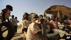 South Sudanese children wait outside their tent at Andalus camp during a visit by UN High Commissioner for Refugees Antonio Guterres in Khartoum, Sudan, January 11, 2012.