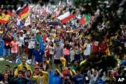 Youths participating in the World Youth Days wait for the arrival of Pope Francis in Krakow's Jordan Park, Poland, July 28, 2016. The Pope is on a five-day visit to Poland which will culminate with the World Youth Day on Sunday.