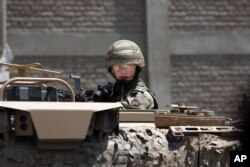 A British soldier guards a site near Kabul's international airport in Kabul, Afghanistan, May 17, 2015. Declining U.S. interest in the war reflects in part the declining number of U.S. casualties there.