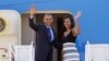 President Barack Obama and first lady Michelle Obama wave prior to boarding Air Force One before departing for a week-long trip to Senegal, South Africa, and Tanzania, June 26, 2013. 