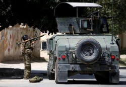 FILE - A member of the Afghan security forces prepares to fire an RPG during a battle with insurgents in Kabul, Afghanistan, Aug. 16, 2018.