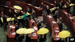 香港民主派立法會議員星期三舉起黃色雨傘，在梁振英發表年度施政報告時離場抗議