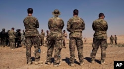 FILE - U.S. special operations forces watch troops from Iraq, Jordan and Lebanon during a multinational military exercise in Zarqa, Jordan, in 2013.