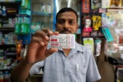 FILE - A chemist displays hydroxychloroquine tablets in Mumbai, India, May 19, 2020.