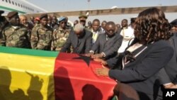 Guinea-Bissau's interim President Raimundo Pereira (C) touches on January 14, 2012 the coffin of late President Malam Bacai Sanha, who died in on January 9, 2012 at a Paris hospital, upon its return to Bissau.