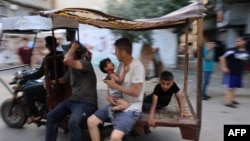 A driver rushes to transport casualties after Israeli bombardment at al-Bureij refugee camp in the central Gaza Strip on July 8, 2024, amid the ongoing conflict between Israel and the Palestinian Hamas militant group.