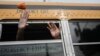FILE - Exiled Nicaraguans released from a Nicaraguan jail wave from a bus after arriving at the airport in Guatemala City, Sept. 5, 2024.