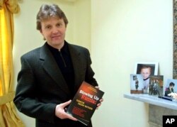 FILE - This May 10, 2002, photo shows Alexander Litvinenko, former KGB spy and author of "Blowing Up Russia: Terror From Within," at his home in London.