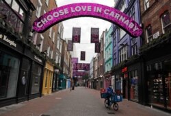 FILE - A nearly empty Carnaby Street in London, Nov. 6, 2020 during a lockdown which shuttered restaurants, hairdressers and clothing stores.