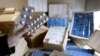 FILE - A Swiss customs officer holds up counterfeit medication in Bardonnex, near Geneva, February 10, 2010.