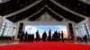 Delegates stand outside the plenary session hall at the ASEAN Summit in Vientiane, Laos, Sept. 6, 2016. 