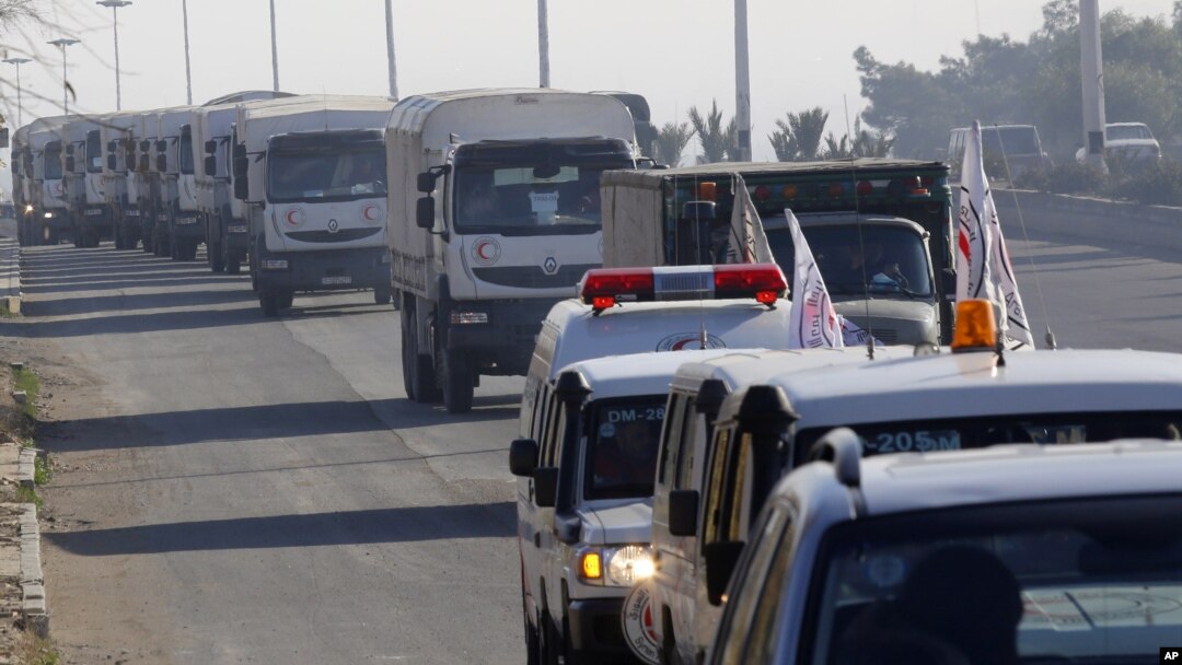 FILE - A convoy of trucks loaded with humanitarian supplies heads to the besieged town of Madaya, 24 kilometers southwest of Damascus, Syria, Jan. 14, 2016.