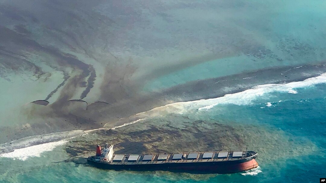 This photo taken and provided by Eric Villars shows oil leaking from the MV Wakashio, a bulk carrier ship that recently ran aground off the southeast coast of Mauritius, Aug. 7, 2020.