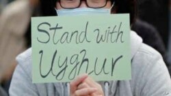 A man holds a sign during a rally to show support for Uighurs and their fight for human rights in Hong Kong, Sunday, Dec. 22, 2019.