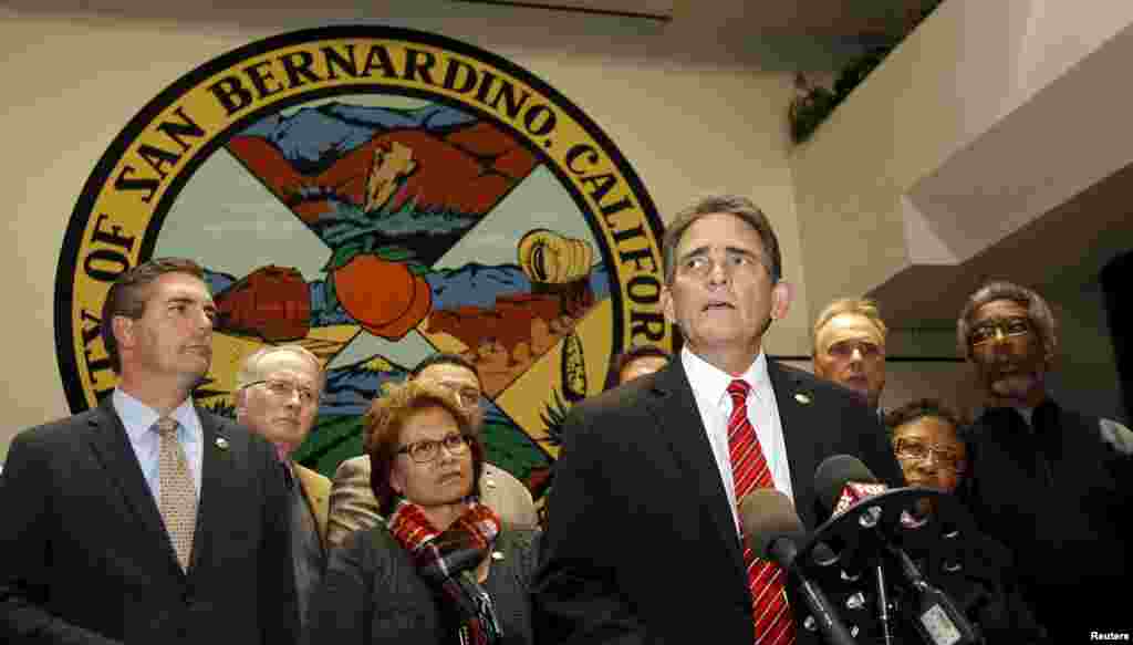 Mayor Carey Davis (C) talks to the media, after an emergency city council meeting, with all of the council behind him, about the shooting rampage at the Inland Regional Center, where gunmen shot and killed several people and injured others in San Bernardino, California, Dec. 2, 2015.
